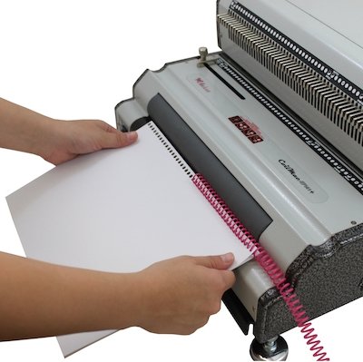 Inserting plastic coil into covers and paper
